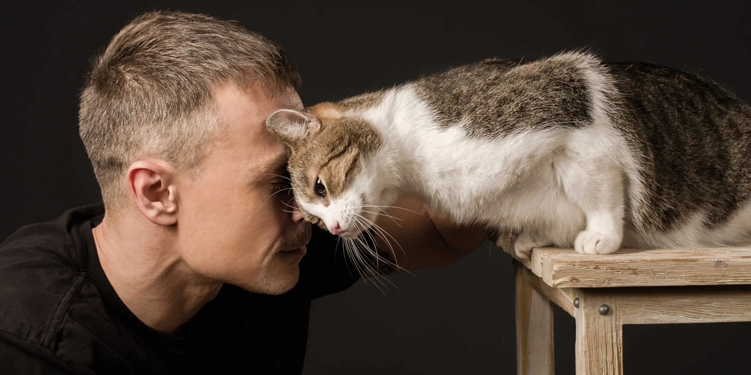 man cuddling cat